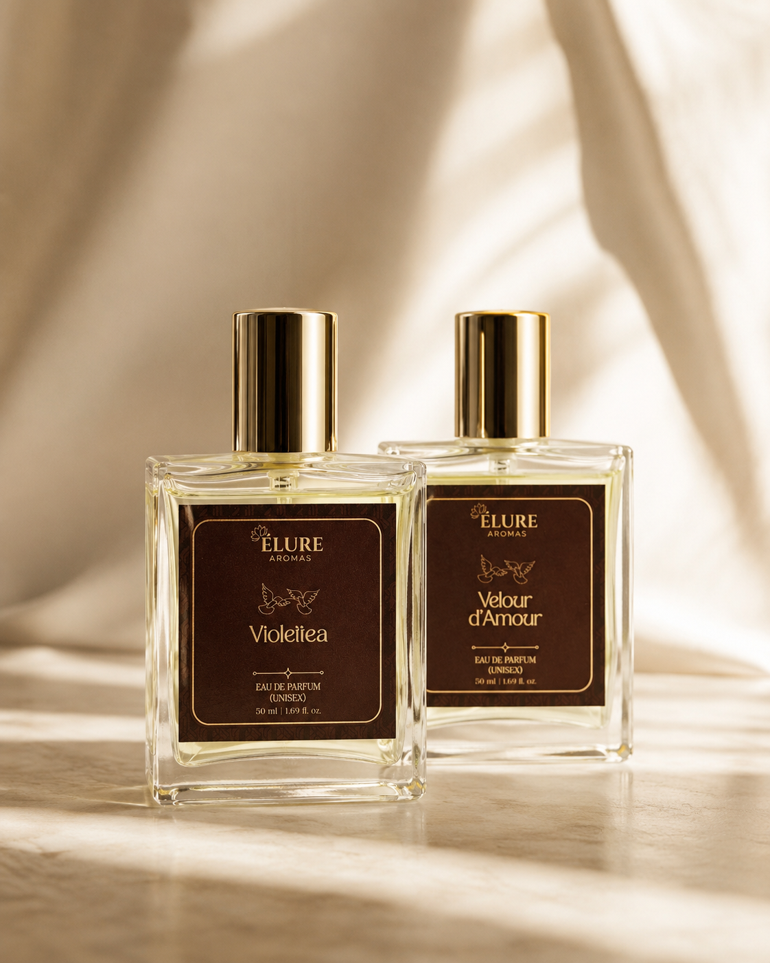 Legacy - Violettea and Velour d'Amour 50ml bottles in raking daylight